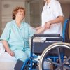 Thumb 5824461 nurse helping an elderly woman onto a wheelchair at the hospital