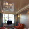 Thumb the colour of the new stretch ceiling may blend right in but a shiny ceiling is always outstanding so the new ceiling fits with this brilliant orange pouf furniture and an artistic asymmetrical tv console.